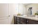 Bright bathroom featuring a double sink vanity with granite countertop and modern fixtures at 2030 Majorca Dr, Kissimmee, FL 34747