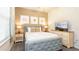 Comfortable bedroom featuring neutral tones, stylish decor, and a large TV at 2030 Majorca Dr, Kissimmee, FL 34747