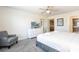 Relaxing bedroom with a plush bed, dresser, and an adjacent seating area at 2030 Majorca Dr, Kissimmee, FL 34747