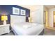 Cozy bedroom featuring a comfortable bed, nautical-themed decor, and ample closet space at 2030 Majorca Dr, Kissimmee, FL 34747