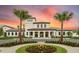 Stunning clubhouse with beautiful landscaping, and plenty of parking surrounded by palm trees at 2030 Majorca Dr, Kissimmee, FL 34747