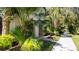 Exterior of a home with tropical landscaping and a brick walkway leading to the entrance at 2030 Majorca Dr, Kissimmee, FL 34747