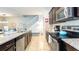 Well-equipped kitchen with dark cabinets, granite countertops, and stainless steel appliances at 2030 Majorca Dr, Kissimmee, FL 34747