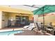 Inviting patio area featuring poolside furniture, a ceiling fan, and access to the home's interior at 2030 Majorca Dr, Kissimmee, FL 34747