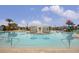 Resort-style pool with lounge chairs, umbrellas, and a splash pad area perfect for Gathering fun at 2030 Majorca Dr, Kissimmee, FL 34747