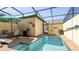 Enjoy this inviting screened-in pool area with a table, chairs, and a grill perfect for outdoor entertaining at 2030 Majorca Dr, Kissimmee, FL 34747