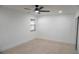 Minimalist bedroom with a ceiling fan, neutral walls, and tiled flooring at 240 W Palmetto Ave, Deland, FL 32720