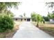 Charming single-story home with a long driveway and lush landscaping at 240 W Palmetto Ave, Deland, FL 32720