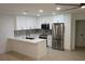 Modern kitchen featuring white cabinets, stainless steel appliances, and marble countertops at 240 W Palmetto Ave, Deland, FL 32720