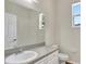 Bathroom featuring white cabinets and large mirror at 2468 Cimmaron Ash Way, Apopka, FL 32703