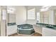 Bathroom featuring a large garden tub with green stone and double sink at 2468 Cimmaron Ash Way, Apopka, FL 32703