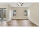 Spacious bedroom featuring hardwood floors, two windows, and a ceiling fan at 2468 Cimmaron Ash Way, Apopka, FL 32703