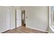 A cozy bedroom featuring hardwood floors and a closet at 2468 Cimmaron Ash Way, Apopka, FL 32703
