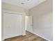Bright bedroom features wood-look flooring and a closet with bi-fold doors at 2468 Cimmaron Ash Way, Apopka, FL 32703