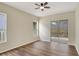 Bright bedroom with hardwood floors, ceiling fan and a glass sliding door at 2468 Cimmaron Ash Way, Apopka, FL 32703