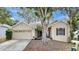 Charming single-story home featuring a manicured lawn, two-car garage, and inviting front entrance at 2468 Cimmaron Ash Way, Apopka, FL 32703