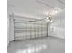 Spacious garage with sealed concrete floor and an automatic door with windows at 2468 Cimmaron Ash Way, Apopka, FL 32703