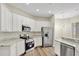 Bright kitchen offers white cabinetry, stainless steel appliances, and granite countertops with ample counter space at 2468 Cimmaron Ash Way, Apopka, FL 32703