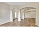Living room showing hardwood floors, decorative archways, and well-lit interior spaces at 2468 Cimmaron Ash Way, Apopka, FL 32703