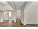 Open-concept living room features hardwood floors, archways, and seamless flow into other living spaces at 2468 Cimmaron Ash Way, Apopka, FL 32703