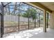 A view of the screened in patio, showing the yard and partial fence beyond it at 2468 Cimmaron Ash Way, Apopka, FL 32703