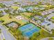 Aerial view of community amenities with water park, tennis courts, and neighborhood homes at 257 Auburn Ave, Kissimmee, FL 34747