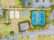 Aerial view of the community amenities including tennis courts, basketball court, and beach volleyball at 257 Auburn Ave, Kissimmee, FL 34747