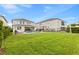 Spacious backyard with a pool, patio, and green lawn, ideal for outdoor activities at 257 Auburn Ave, Kissimmee, FL 34747