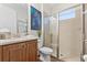 Well-lit bathroom featuring a vanity, toilet, and glass-enclosed shower with tiled walls for a clean and modern look at 257 Auburn Ave, Kissimmee, FL 34747