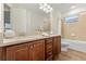 Bathroom featuring a double sink vanity and shower-tub combo at 257 Auburn Ave, Kissimmee, FL 34747