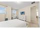 Cozy bedroom showcasing a white bed frame, television, and window seat at 257 Auburn Ave, Kissimmee, FL 34747