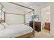 Bedroom featuring a wooden four-poster bed, dresser, and ensuite access at 257 Auburn Ave, Kissimmee, FL 34747
