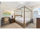 Bedroom with a four-poster bed, desk, and a nightstand with lamp at 257 Auburn Ave, Kissimmee, FL 34747