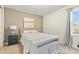 Cozy bedroom featuring neutral tones and large windows, with carpeted floors and closet space at 257 Auburn Ave, Kissimmee, FL 34747