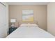 Neutral-toned bedroom with an understated headboard, stylish nightstand, and carpeted floors at 257 Auburn Ave, Kissimmee, FL 34747