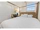 Bedroom with a four-poster bed, desk, and double-door closet at 257 Auburn Ave, Kissimmee, FL 34747