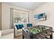Comfortable bonus room features a sofa, television, and foosball table, perfect for Gathering time and entertainment at 257 Auburn Ave, Kissimmee, FL 34747