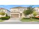 Charming two-story home featuring a well-manicured front yard and a two-car garage at 257 Auburn Ave, Kissimmee, FL 34747