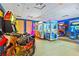 Bright game room featuring modern arcade games and colorful decor at 257 Auburn Ave, Kissimmee, FL 34747