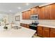 Modern kitchen features stainless steel appliances, stone countertops, and warm wood cabinets at 257 Auburn Ave, Kissimmee, FL 34747
