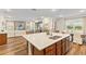 Modern kitchen with an island, stainless steel appliances, and open layout connecting to the living and dining areas at 257 Auburn Ave, Kissimmee, FL 34747