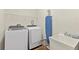 Functional laundry room with modern washer and dryer, shelving, and sink for convenient laundry tasks at 257 Auburn Ave, Kissimmee, FL 34747