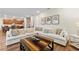 Open-concept living room with a large sectional sofa, stylish decor, and seamless flow to the kitchen and dining area at 257 Auburn Ave, Kissimmee, FL 34747