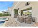 Inviting covered patio with outdoor kitchen, ceiling fans, dining table, and access to the pool for relaxing and entertaining at 257 Auburn Ave, Kissimmee, FL 34747