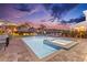 Inviting pool with a spa, lounge seating, and an outdoor dining area under a twilight sky at 257 Auburn Ave, Kissimmee, FL 34747