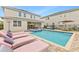 Inviting backyard pool area with lounge chairs and patio furniture, perfect for relaxation at 257 Auburn Ave, Kissimmee, FL 34747