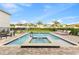 Sparkling pool and spa with a brick patio, lounge chairs, and an outdoor dining area at 257 Auburn Ave, Kissimmee, FL 34747