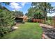 Spacious backyard with lush green lawn, mature trees, and vibrant landscaping, perfect for outdoor enjoyment at 2656 Whisper Lakes Club Cir, Orlando, FL 32837