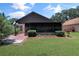 Backyard featuring a screened-in porch and meticulously maintained landscaping at 2656 Whisper Lakes Club Cir, Orlando, FL 32837