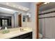 Bathroom with a walk-in shower, single vanity, and lighting at 2656 Whisper Lakes Club Cir, Orlando, FL 32837